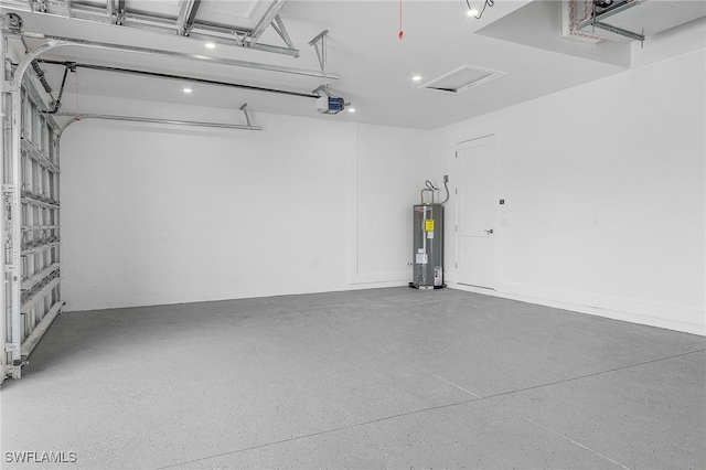 garage featuring a garage door opener and electric water heater