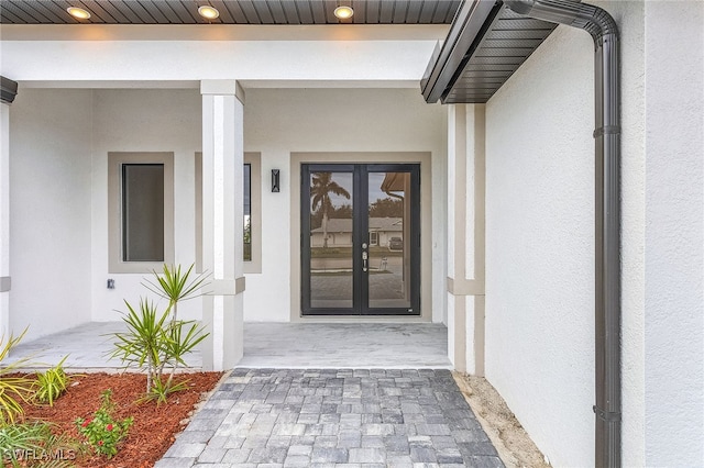 view of exterior entry featuring french doors