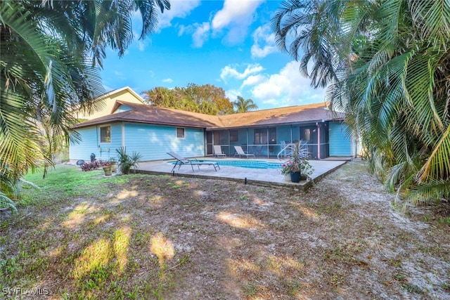 rear view of house with a patio area and a sunroom