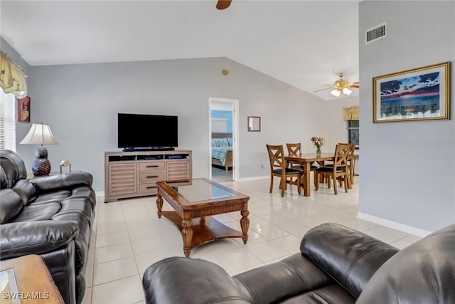 tiled living room featuring ceiling fan and vaulted ceiling