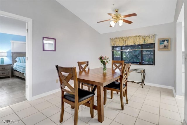 dining room featuring vaulted ceiling, light tile patterned floors, and ceiling fan