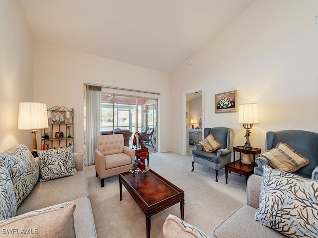 living room with high vaulted ceiling and light carpet