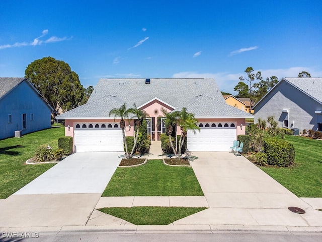 view of front of property with a garage and a front lawn