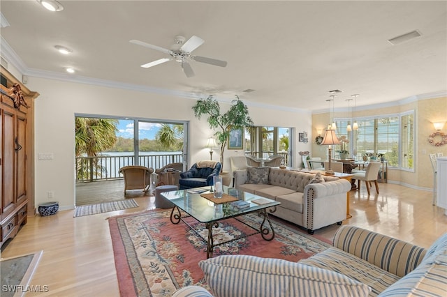 living room featuring ceiling fan, ornamental molding, and light hardwood / wood-style floors