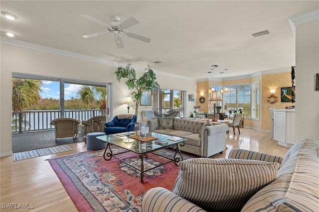 living room with crown molding, ceiling fan with notable chandelier, and light hardwood / wood-style flooring