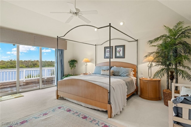 bedroom featuring a water view, ceiling fan, access to exterior, and light carpet