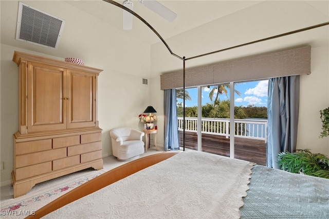 bedroom with ceiling fan, access to exterior, and a high ceiling