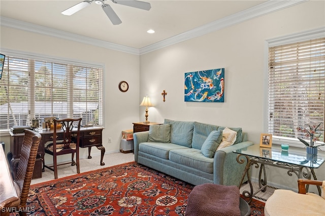 living room with ceiling fan, carpet flooring, baseboards, and ornamental molding