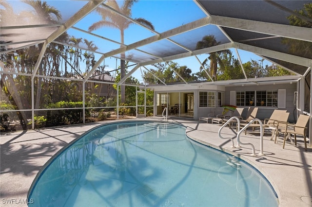 view of pool featuring a patio and glass enclosure