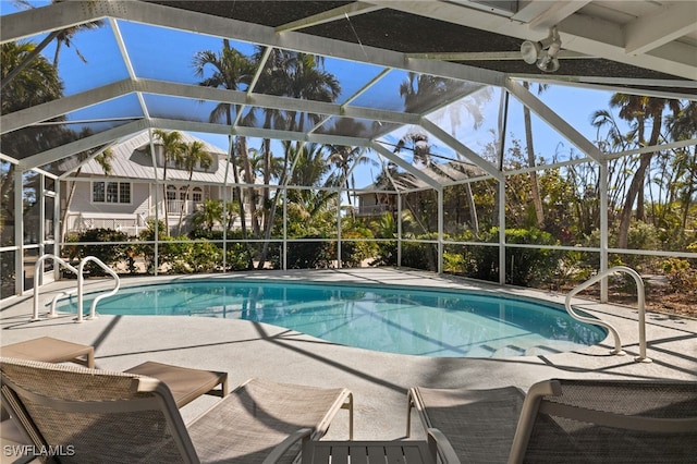 view of swimming pool featuring a patio and glass enclosure