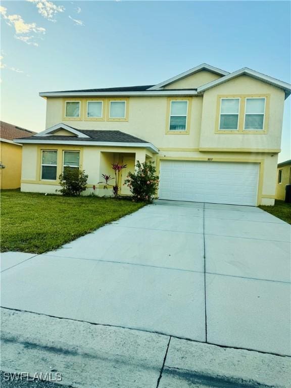 view of front of property featuring a garage and a front yard