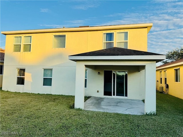 back of property with a patio and a lawn