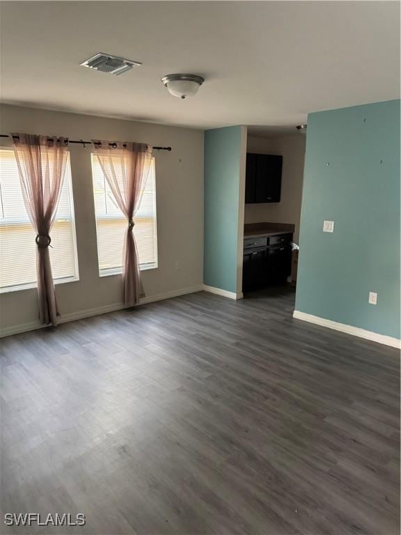 empty room with dark wood-type flooring