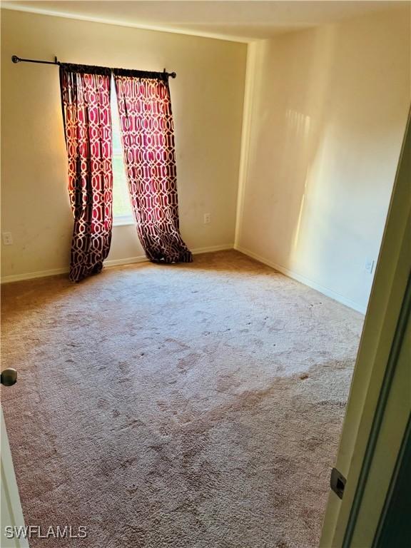 unfurnished room featuring carpet