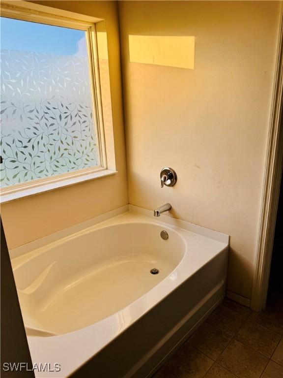 bathroom featuring a bath and tile patterned floors