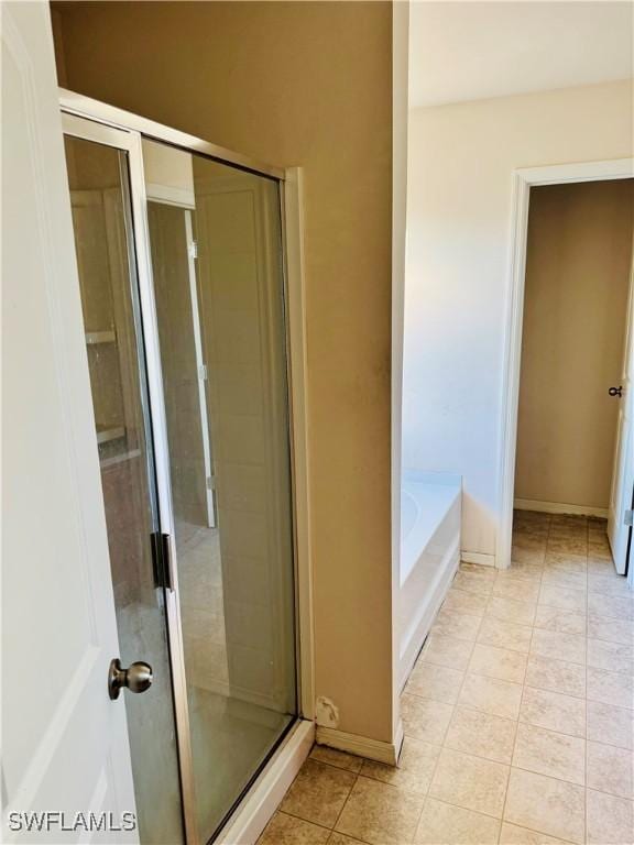 bathroom featuring plus walk in shower and tile patterned floors