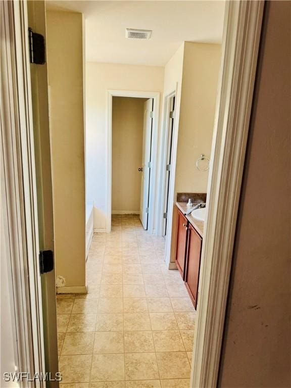 hall with light tile patterned floors