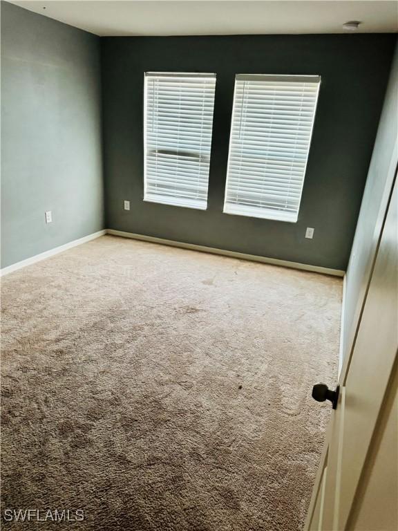 unfurnished room featuring carpet