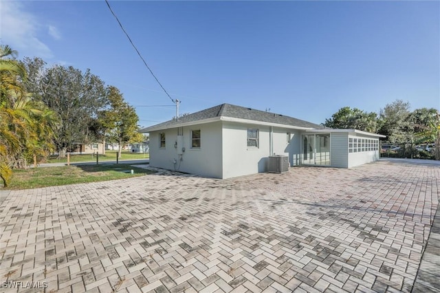 rear view of house featuring central AC unit