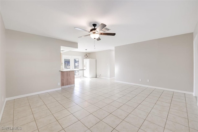 tiled empty room with ceiling fan