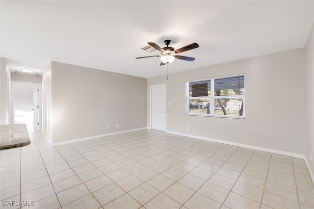 unfurnished room with light tile patterned floors and ceiling fan