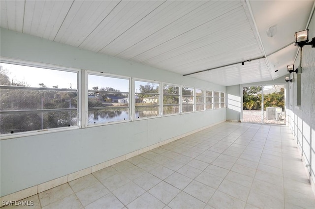 unfurnished sunroom with a water view