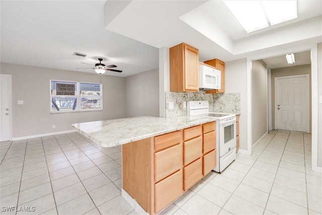 kitchen with tasteful backsplash, light tile patterned flooring, white appliances, and kitchen peninsula