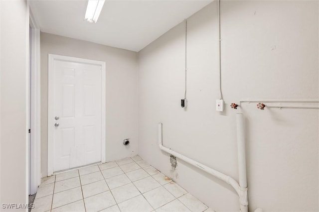 clothes washing area featuring hookup for an electric dryer and light tile patterned floors