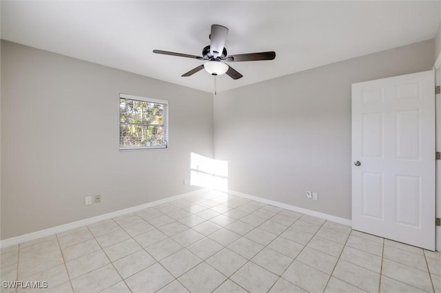 empty room with light tile patterned floors and ceiling fan