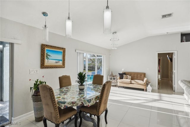 tiled dining space featuring lofted ceiling