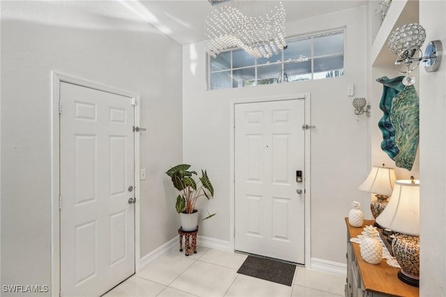 foyer entrance featuring light tile patterned floors and a notable chandelier