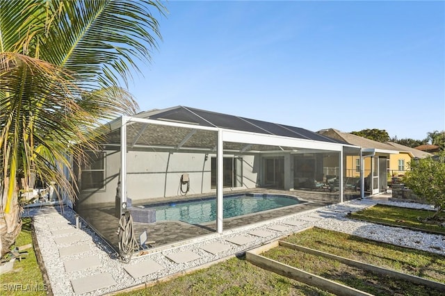 view of swimming pool with a lanai and a patio