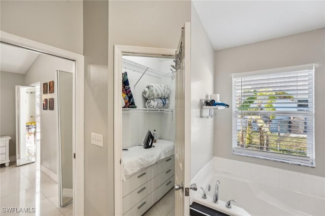 bathroom featuring a washtub and tile patterned flooring