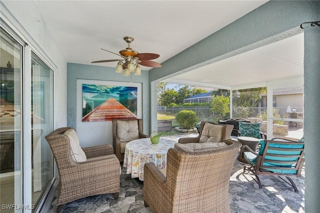 sunroom / solarium featuring ceiling fan