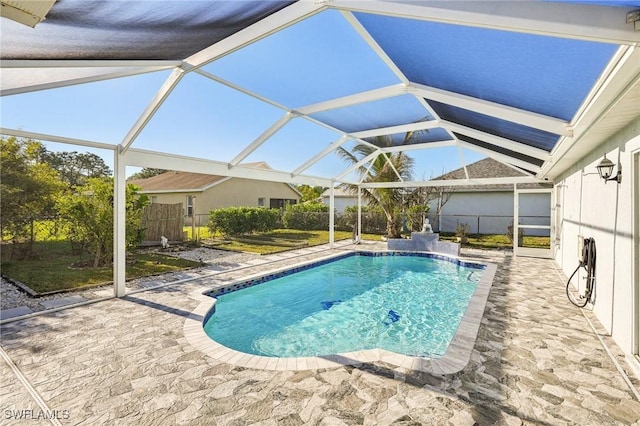 view of pool with a patio and glass enclosure