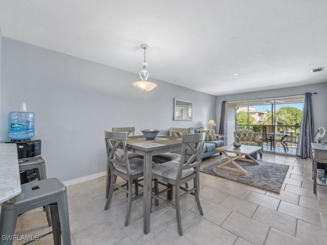 dining space featuring light tile patterned floors