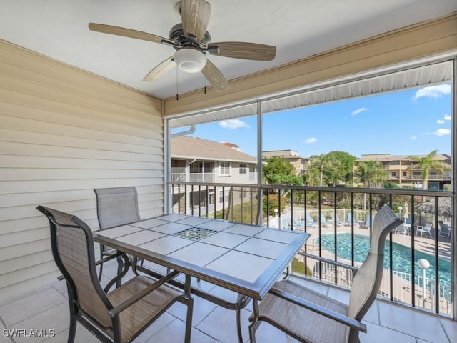 sunroom featuring ceiling fan