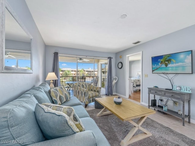 tiled living room with ceiling fan