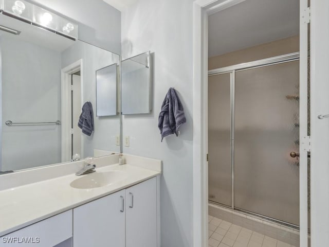 bathroom featuring vanity, tile patterned floors, and walk in shower