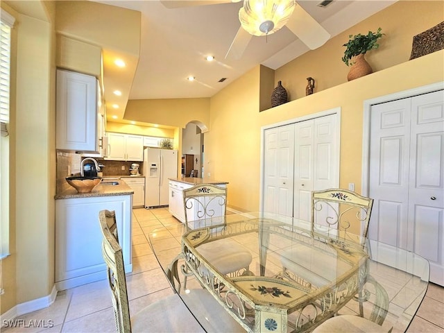 tiled dining room featuring sink and ceiling fan