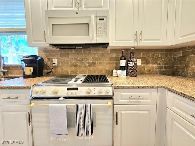 kitchen featuring light stone countertops, white cabinets, white appliances, and decorative backsplash