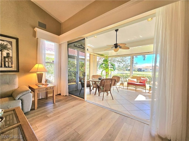 sunroom / solarium featuring ceiling fan and lofted ceiling