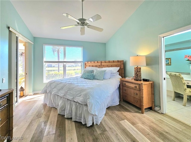 bedroom with lofted ceiling, ceiling fan, and light hardwood / wood-style flooring