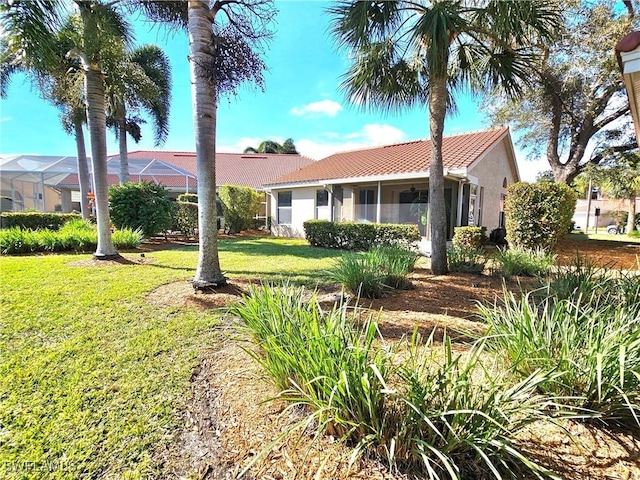 view of front facade with a lanai and a front yard