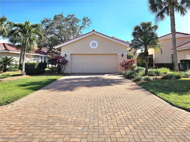 view of front facade with a garage and a front lawn