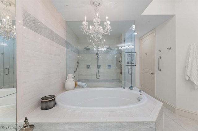 bathroom featuring plus walk in shower, tile walls, a notable chandelier, and tile patterned floors