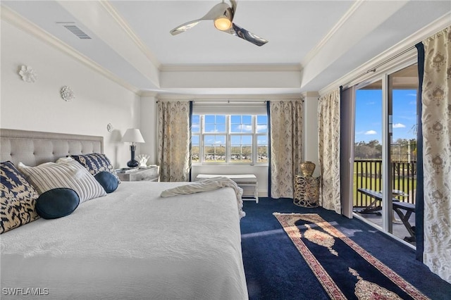 carpeted bedroom featuring a tray ceiling, access to exterior, crown molding, and ceiling fan