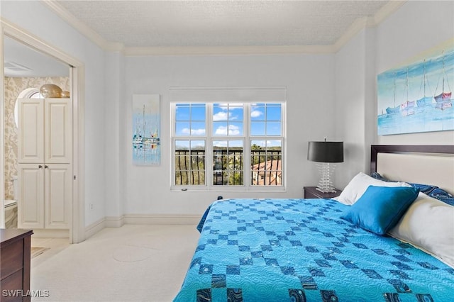 bedroom with ornamental molding, light colored carpet, and a textured ceiling