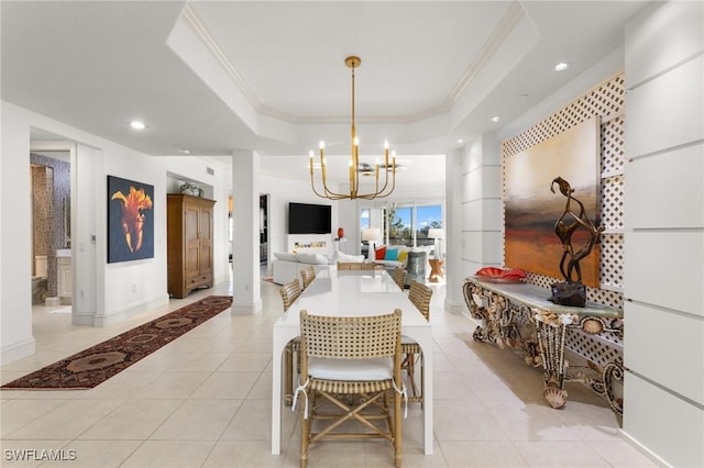 tiled dining space featuring crown molding, a notable chandelier, and a tray ceiling