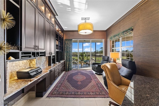 interior space featuring light tile patterned flooring, ornamental molding, and built in features